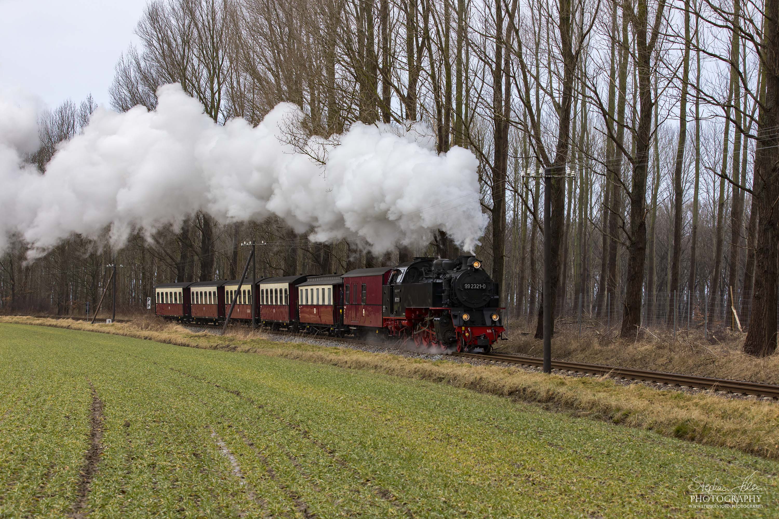 Lok 99 2321-0 mit einem Personenzug der Epoche IV zwischen dem Haltepunkt Steilküste und dem Bahnhof Heiligendamm. Die Zugbildung entspricht der Zeit zwischen 1980 und 1983, als die Personenwagen modernisiert wurden.